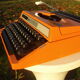Silver reed orange and black typewriter with bag