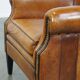 Cognac-colored sheep leather armchair finished with decorative nails