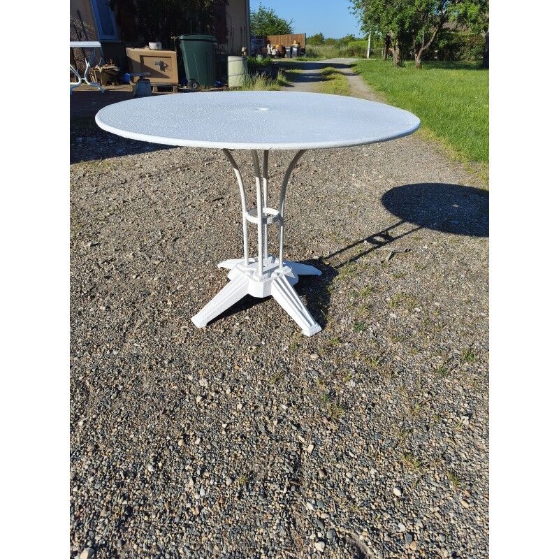 Garden table with a cast iron base and a metal top.