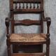 Renaissance-style armchair in solid wood, featuring a columned back