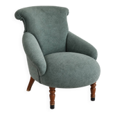 Restored vintage armchair reupholstered in green fabric.