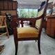 Armchair with scroll arms and sabre legs in mustard velvet, 19th century.