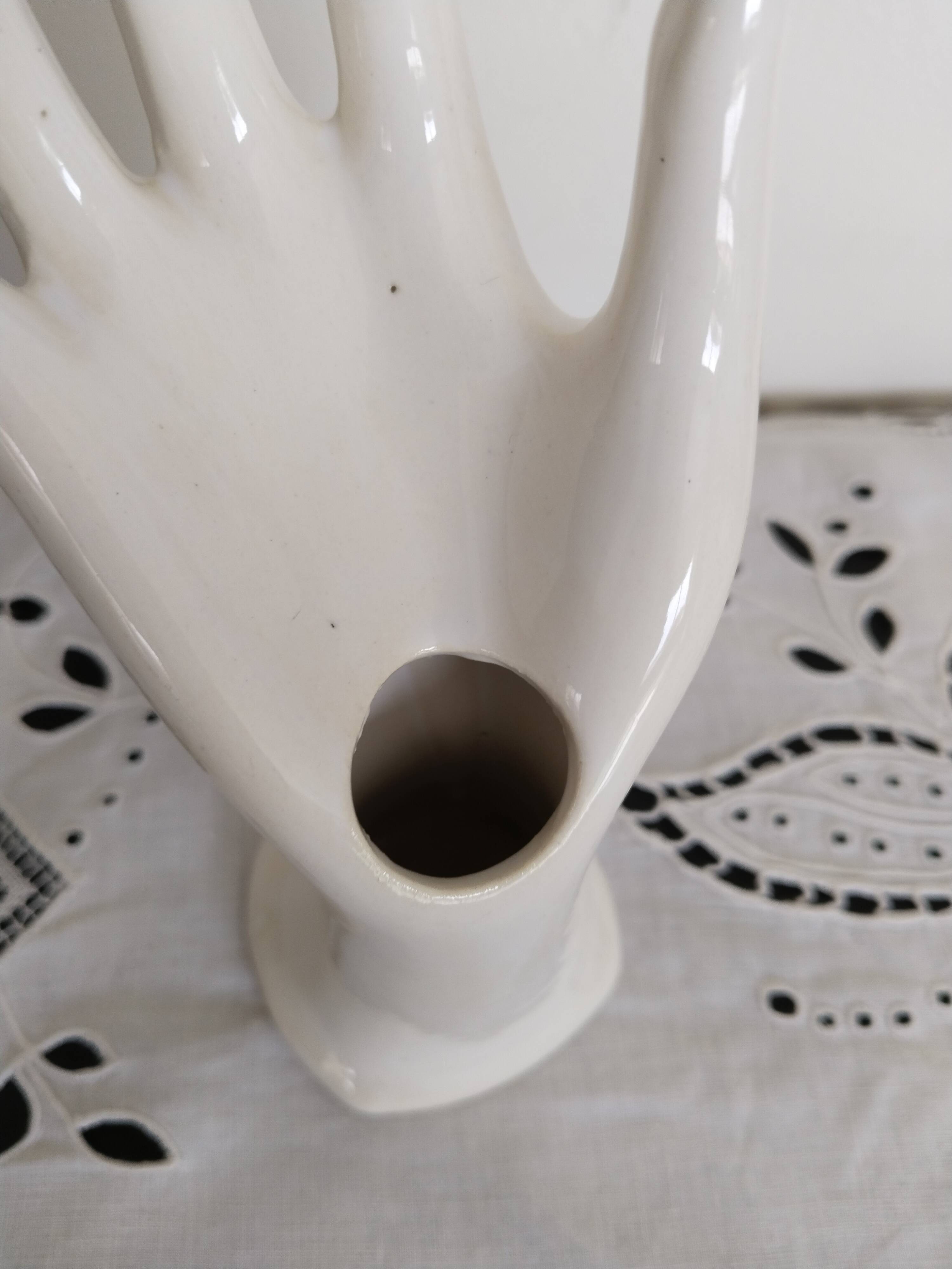 Hand holds white jewelry, ring sizer