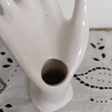 Hand holds white jewelry, ring sizer
