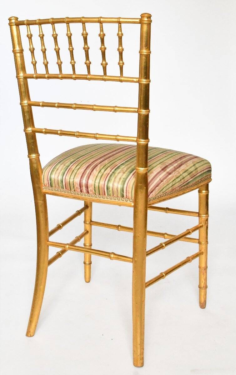Pair of golden wood chairs in a bamboo style.