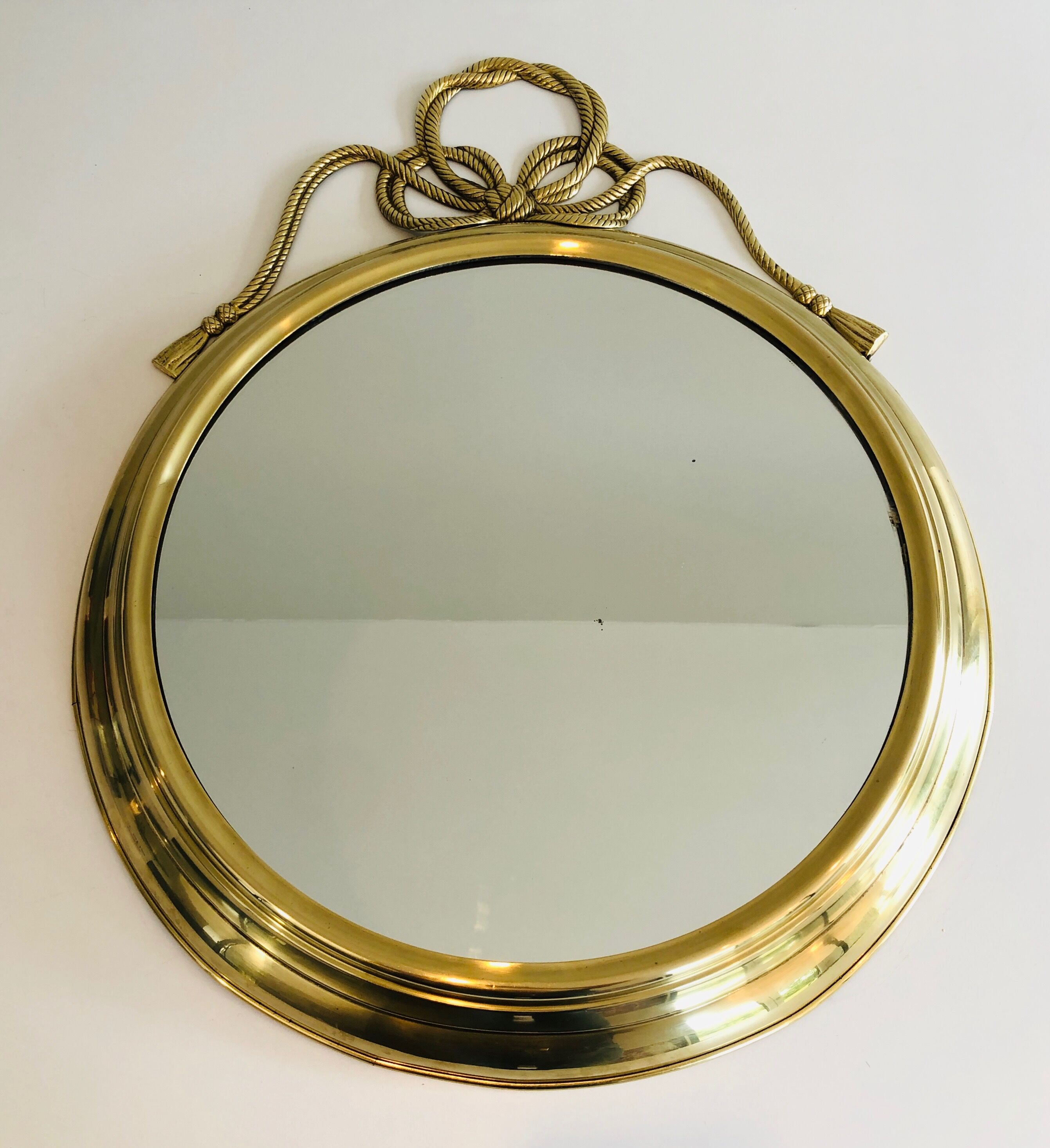 Oval Decorative Mirror in Brass decorated with an Important Twisted Knot