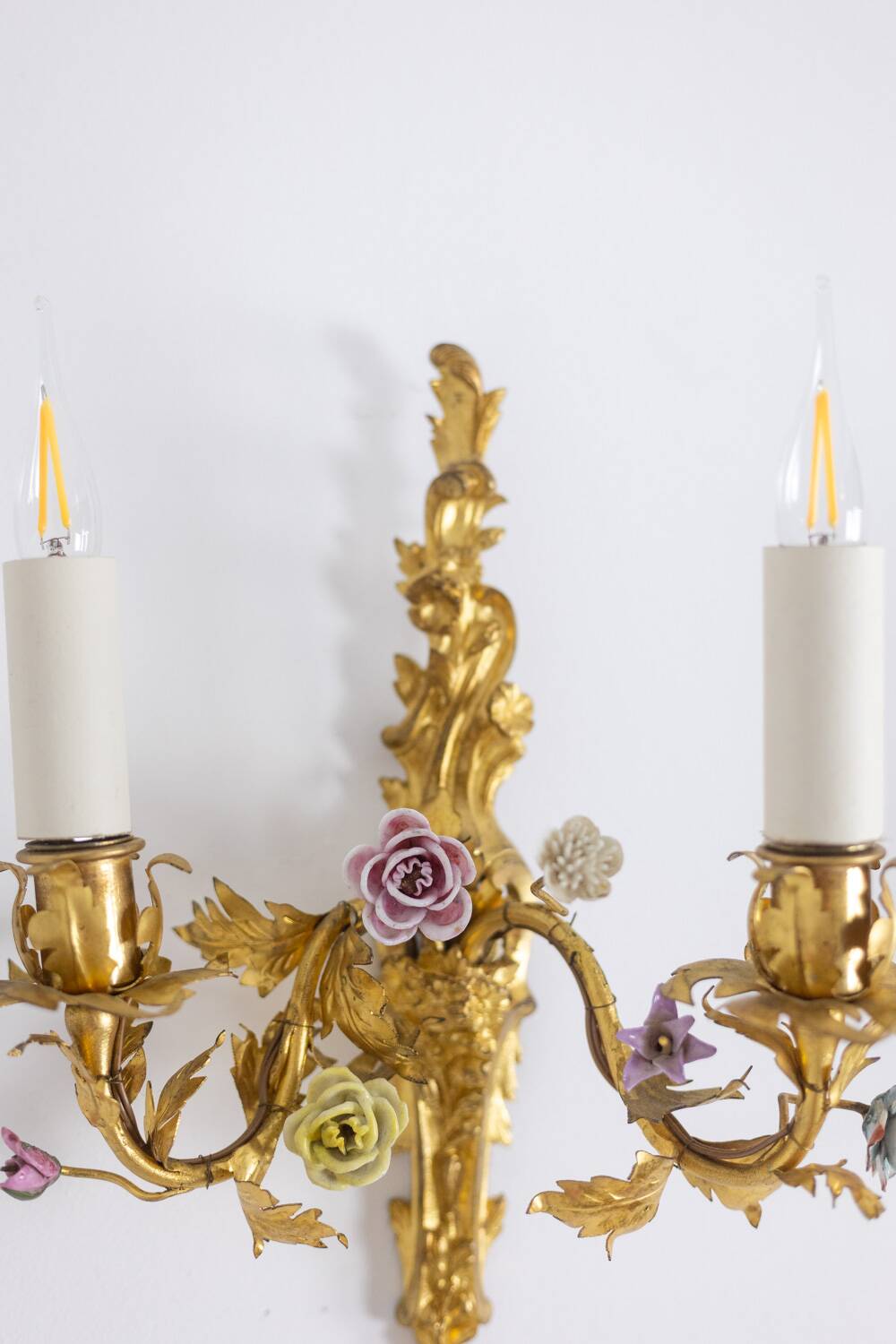 Pair of bronze wall lights with flower decoration. Circa 1880.