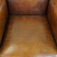 Sheepskin Art Deco design armchair with sleek finish and black piping