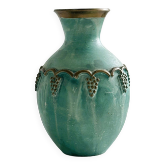 Brass vase decorated with bunches of grapes.