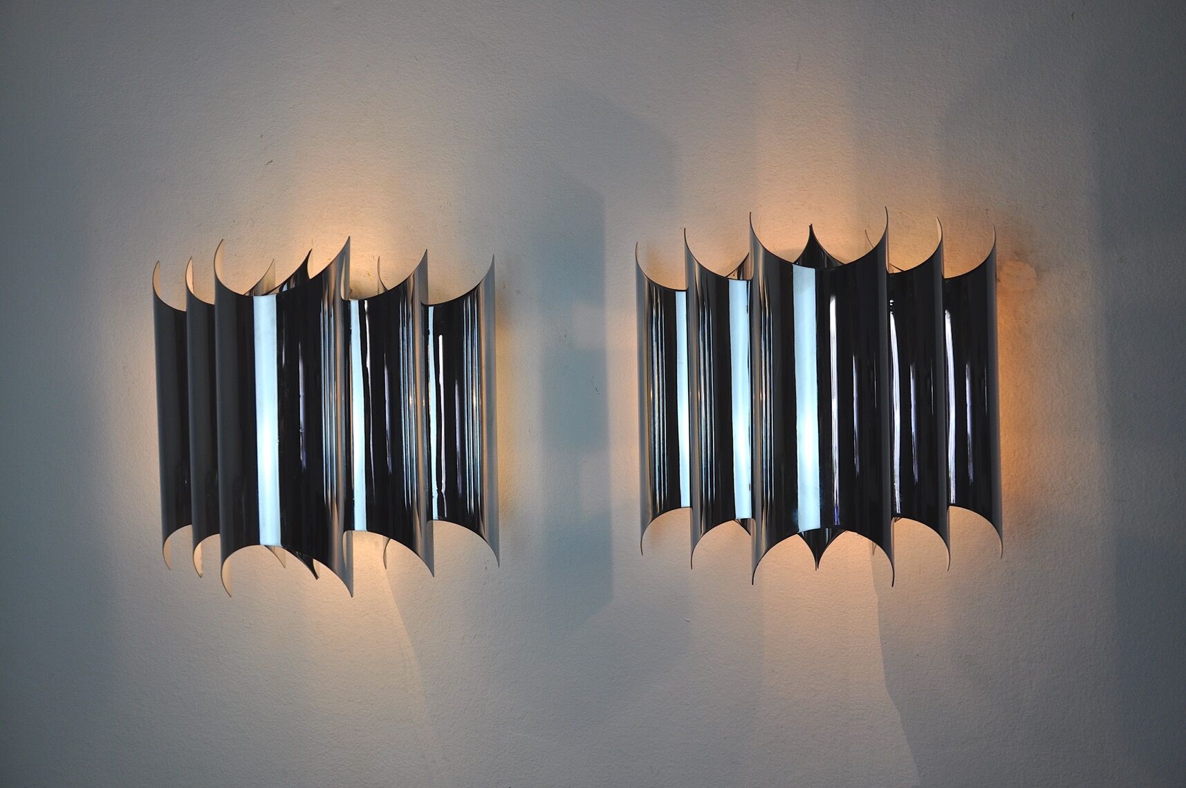 Pair of Raak wall lamps, space-age chrome design, Germany, 1970