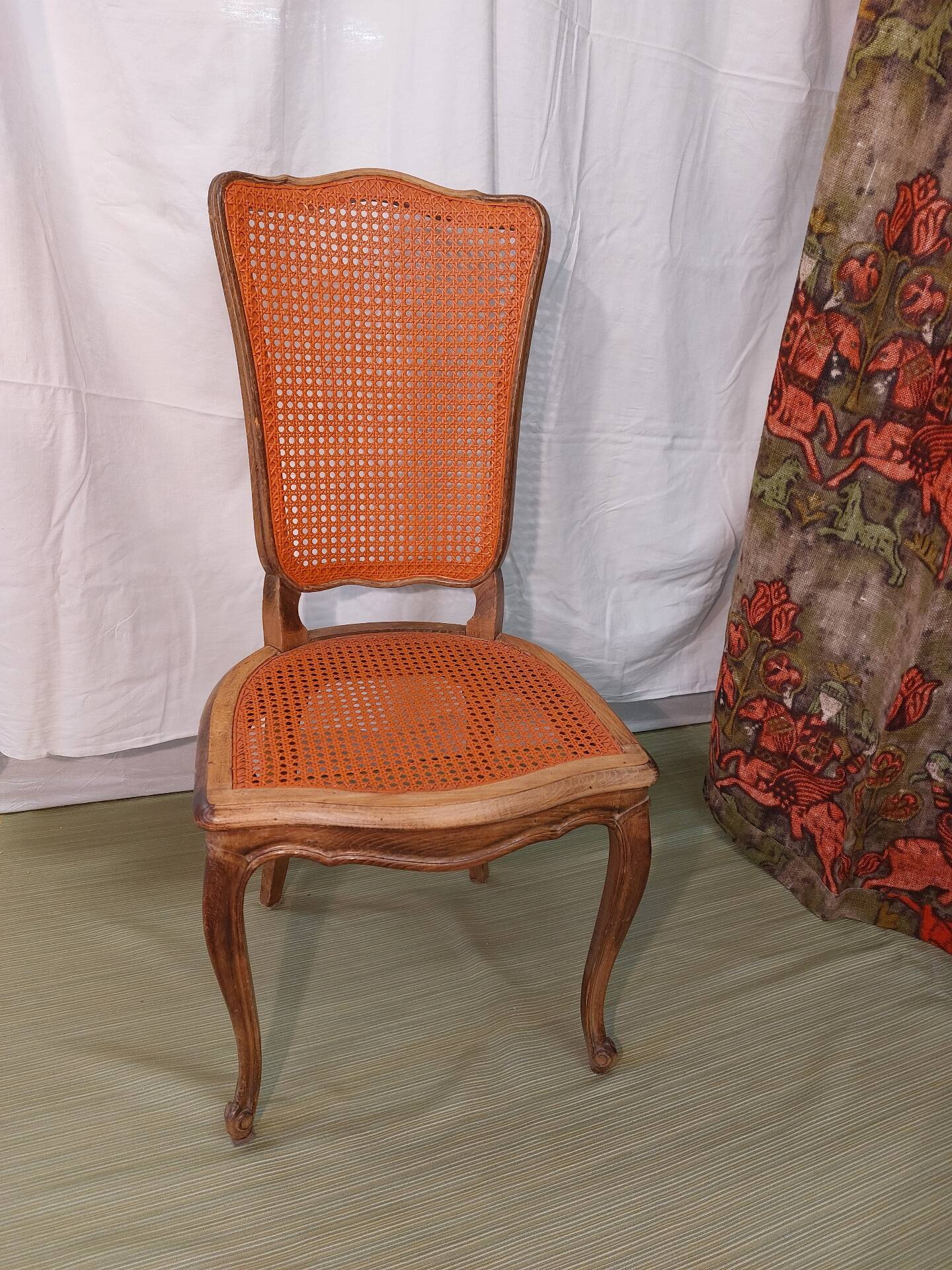 Caned chair in Louis XV style painted orange.