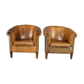 Set of 2 club chairs in patinated sheepskin