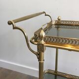 Neoclassical style rolling table in brass with blue glass tops