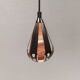 A teardrop-shaped pendant lamp made of copper, black metal, and prisms.