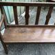 Duo of old solid oak benches with backs and armrests.
