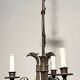 Empire-style bronze chandelier with 3 arms of light topped with eagle heads. French work. Circa 1900.