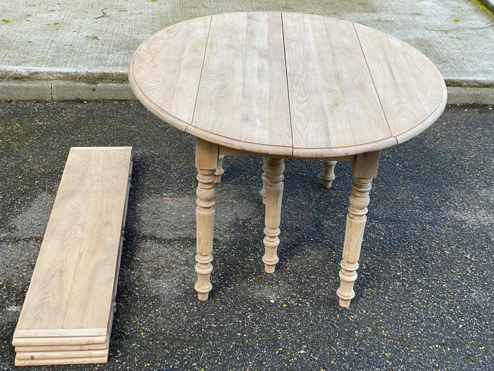 Renovated Louis Philippe round extendable dining table with 4 leaves.