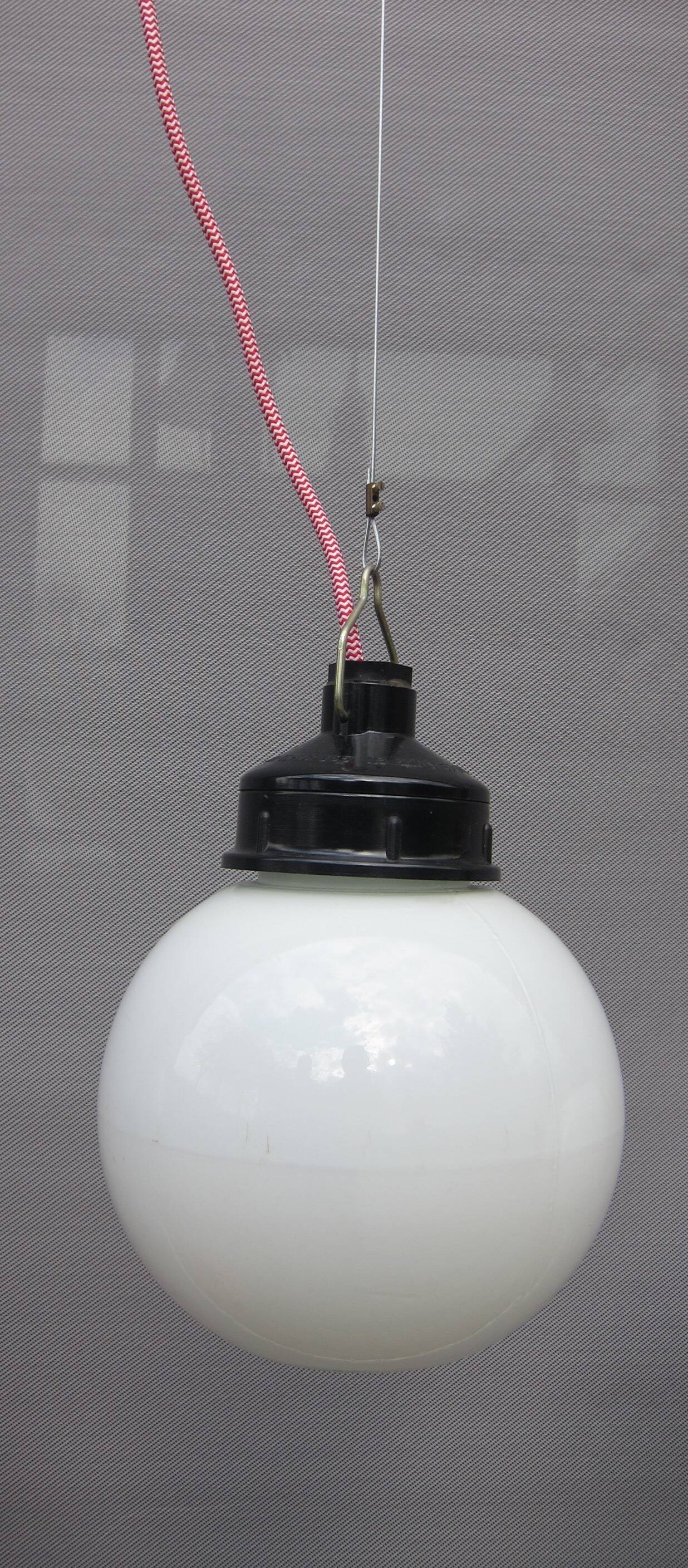 Trio of opal glass and bakelite globe pendant lights