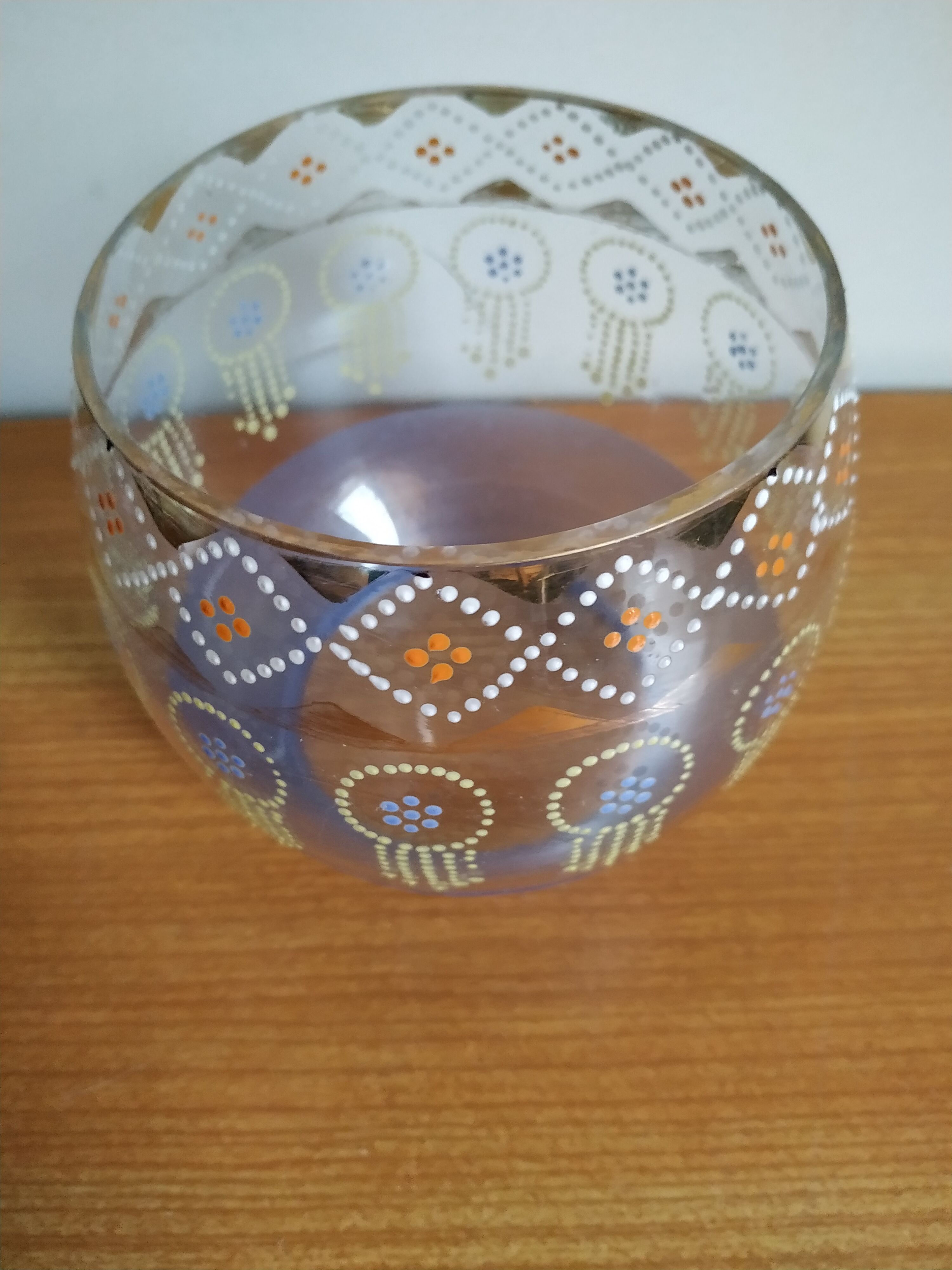 Enamelled glass ball vase decorated with beads and garlands