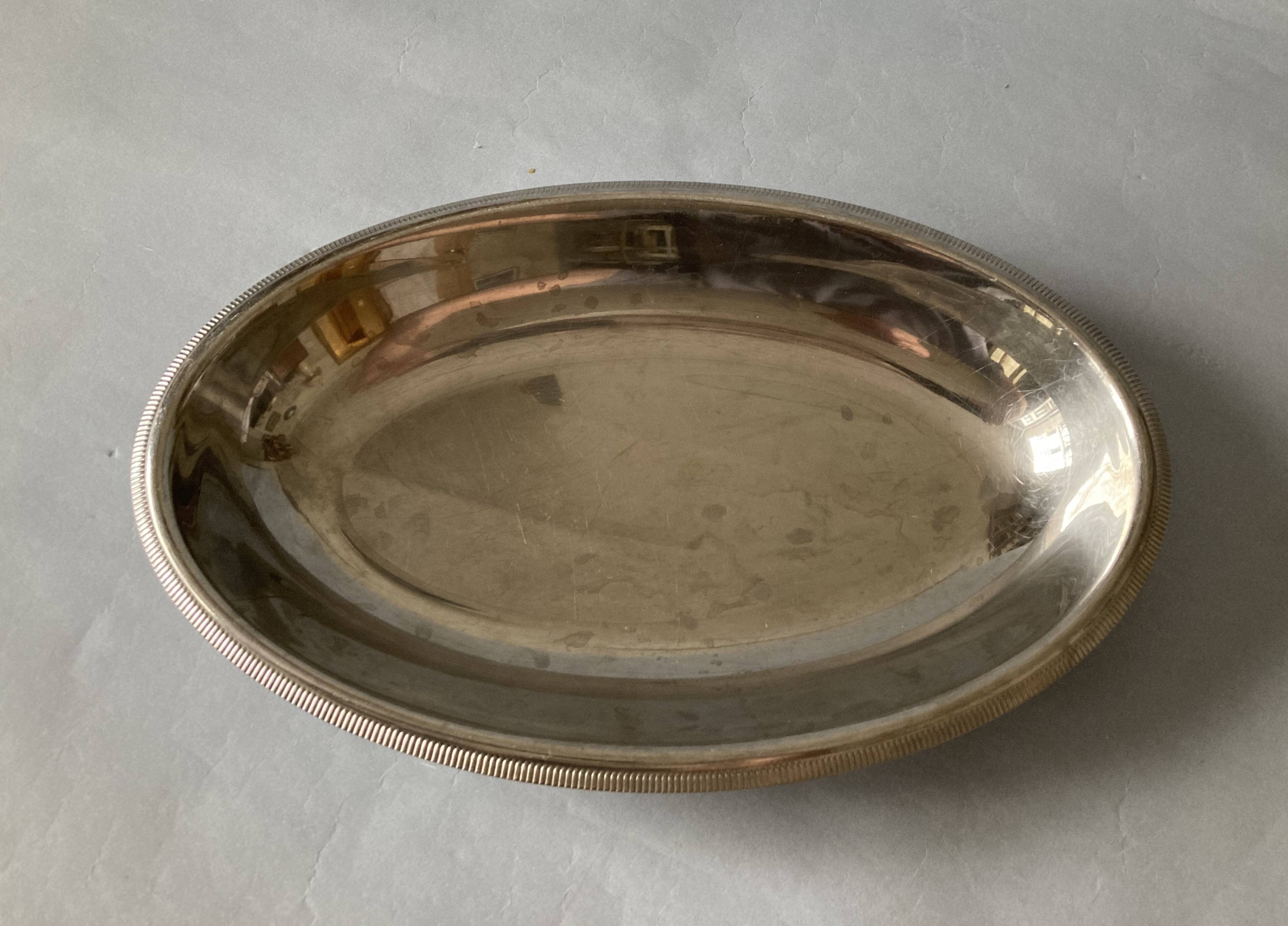 Set of three Letang & Remy stainless steel dishes.