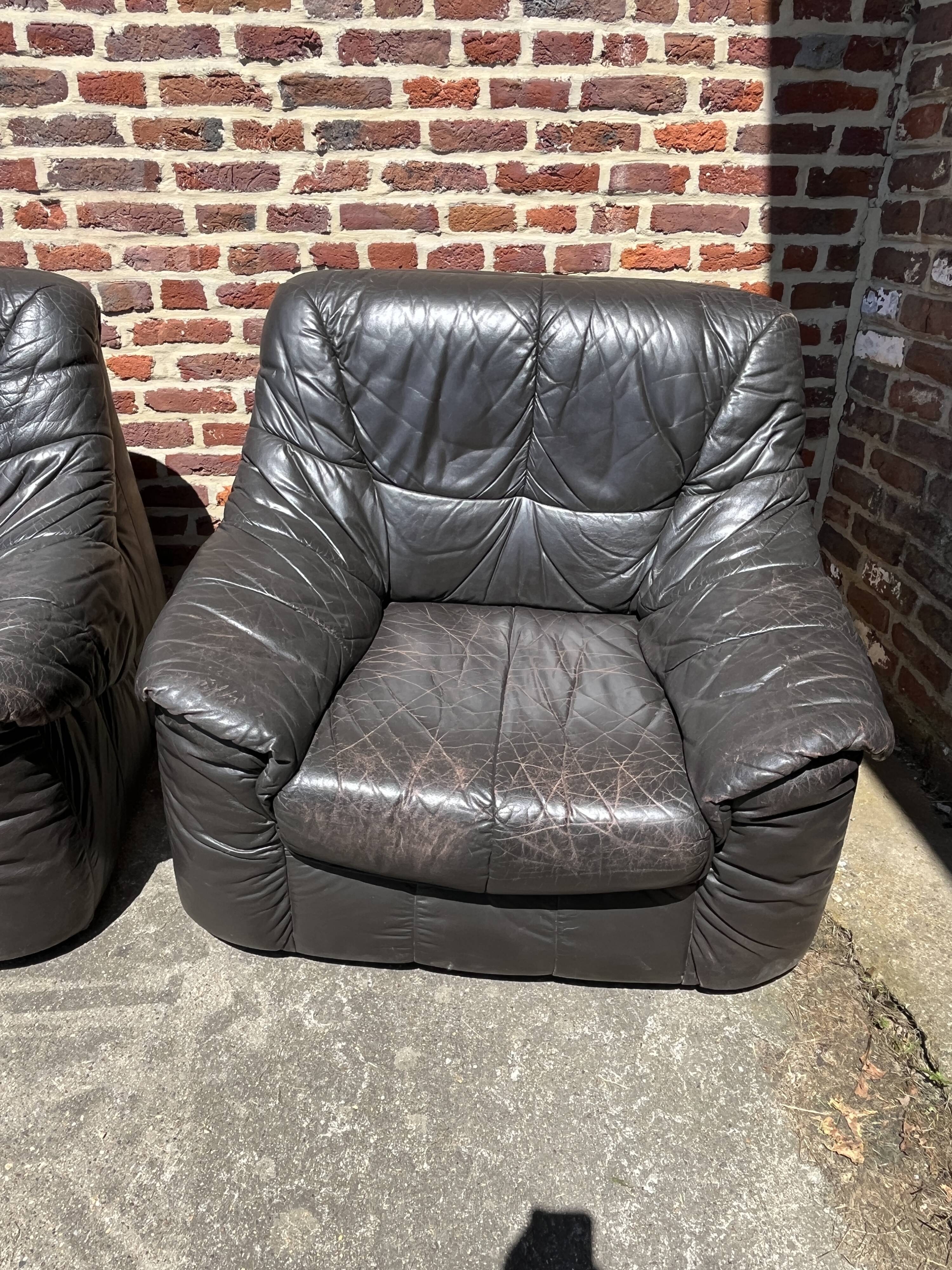 Pair of patinated leather club armchairs