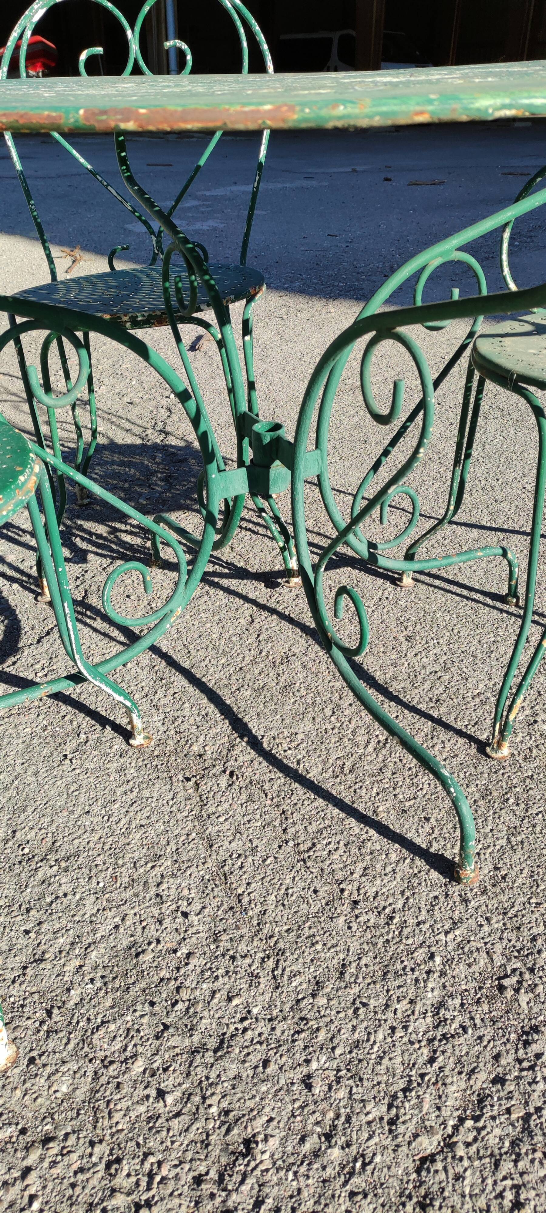 Garden table, two armchairs and a metal chair