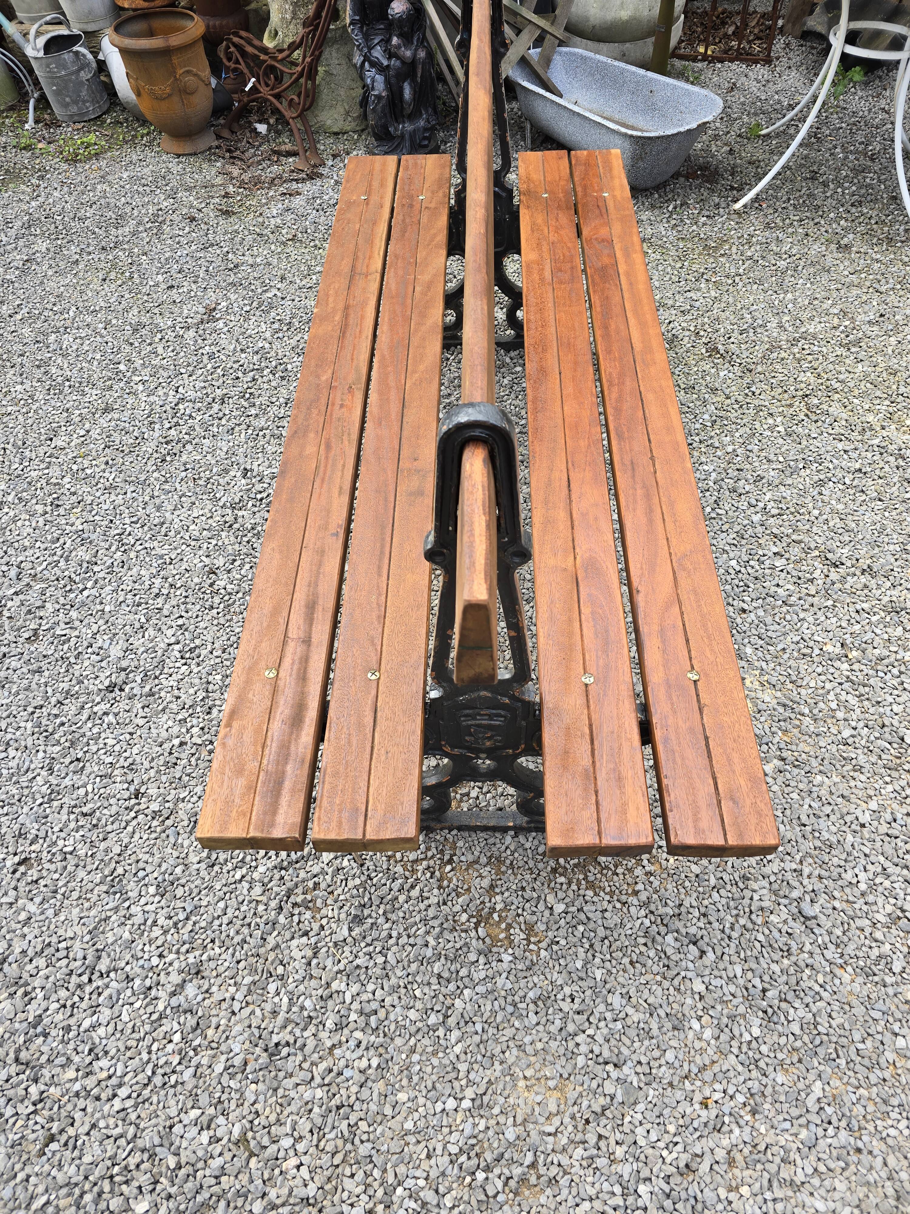Antique double garden bench from the city of Paris in cast iron and wood