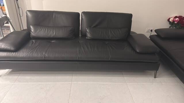 2 black leather sofas roche bobois scenario, one three-seater and one chaise longue.