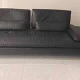 2 black leather sofas roche bobois scenario, one three-seater and one chaise longue.