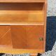 Vintage accent furniture in golden blonde oak with 2 sliding doors.