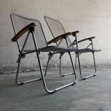 Pair of vintage silver aluminum wire folding chairs with wooden armrests — industrial minimalist