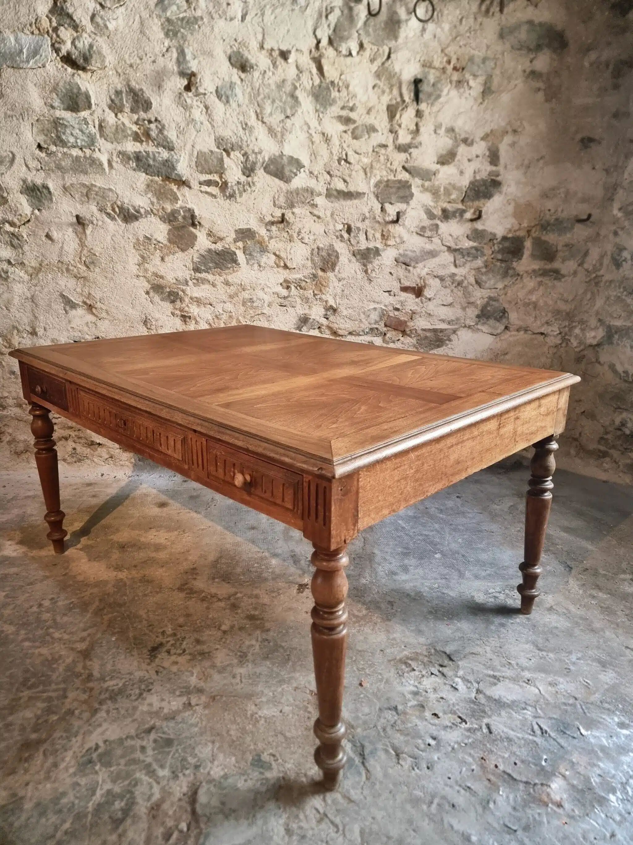 Antique French walnut table with six drawers, parquet top, early 20th century.