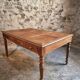 Antique French walnut table with six drawers, parquet top, early 20th century.