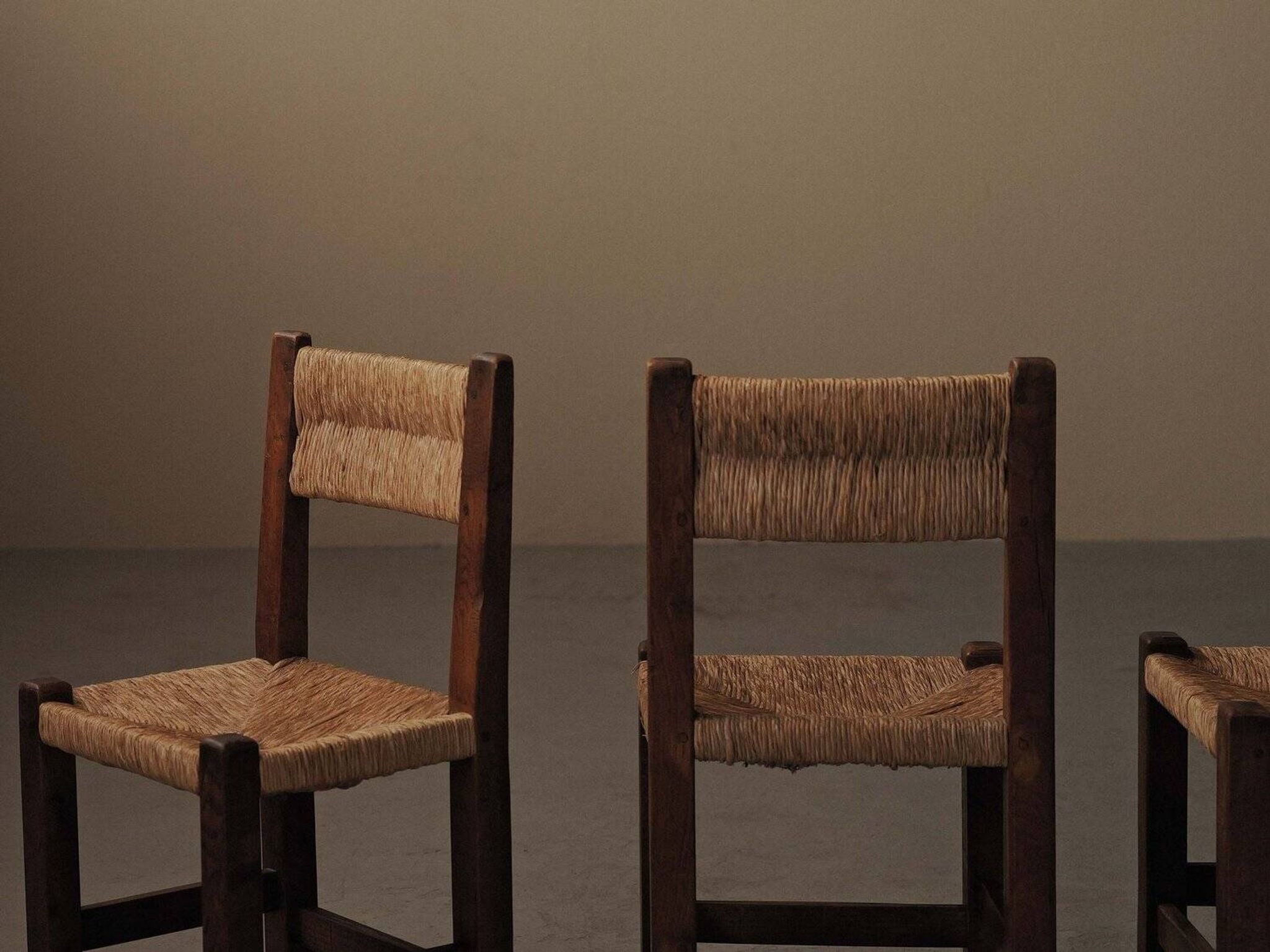 Set of four modernist chairs in oak and straw, France, circa 1960.