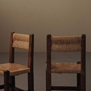 Set of four modernist chairs in oak and straw, France, circa 1960.