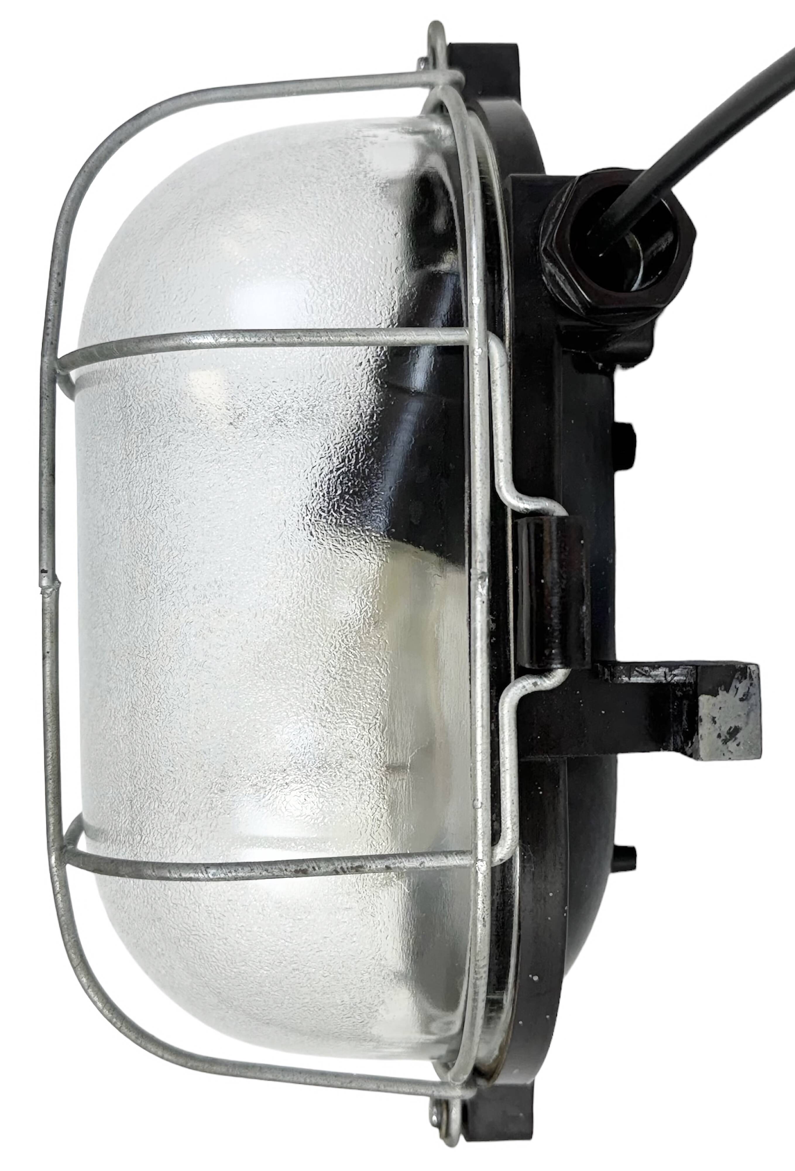 Industrial brown bakelite wall light with frosted glass, 1960s