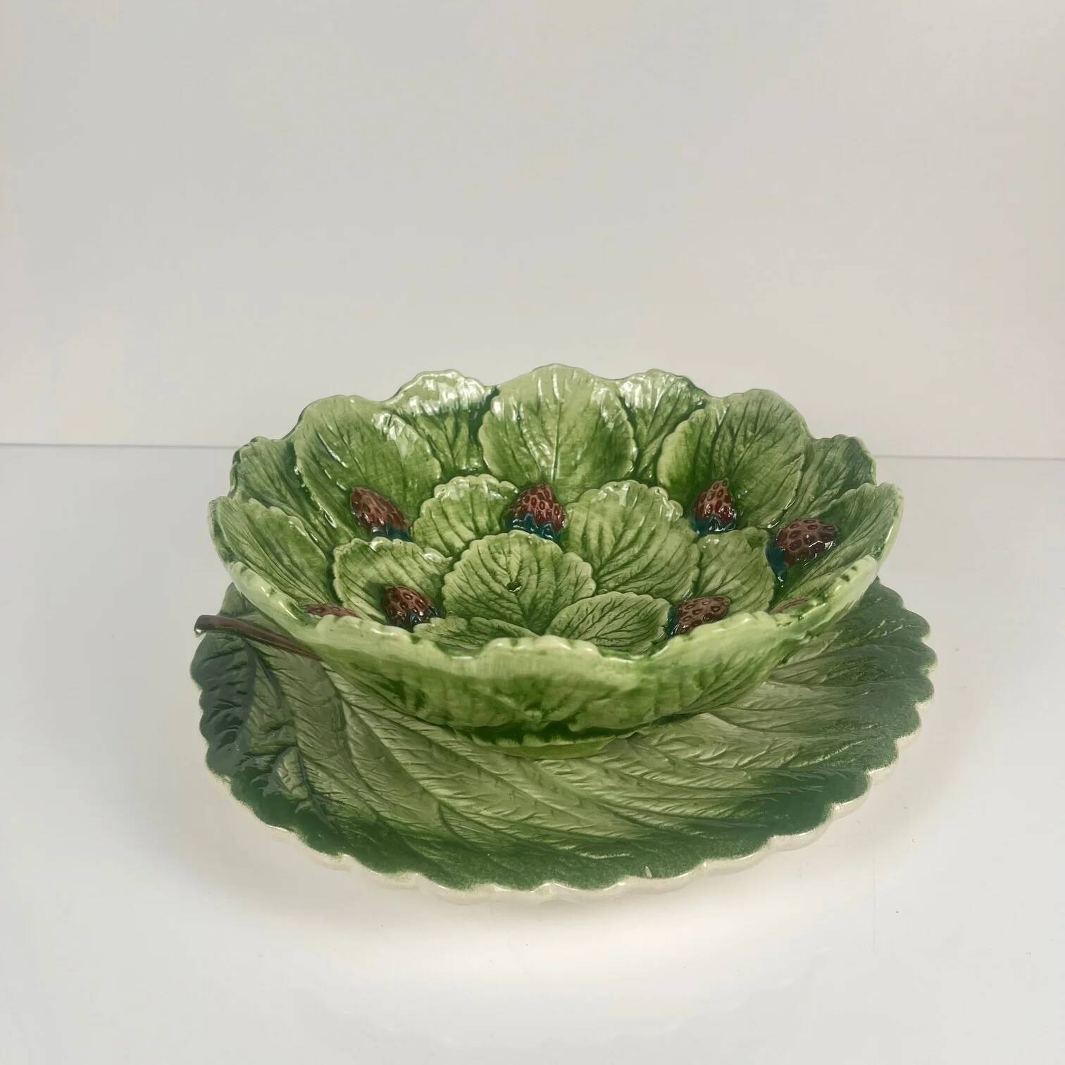 Leaf and strawberry-shaped bowl/strainer.