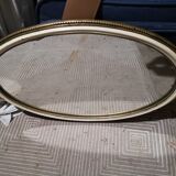 Old oval guilloche mirror, gilded and painted