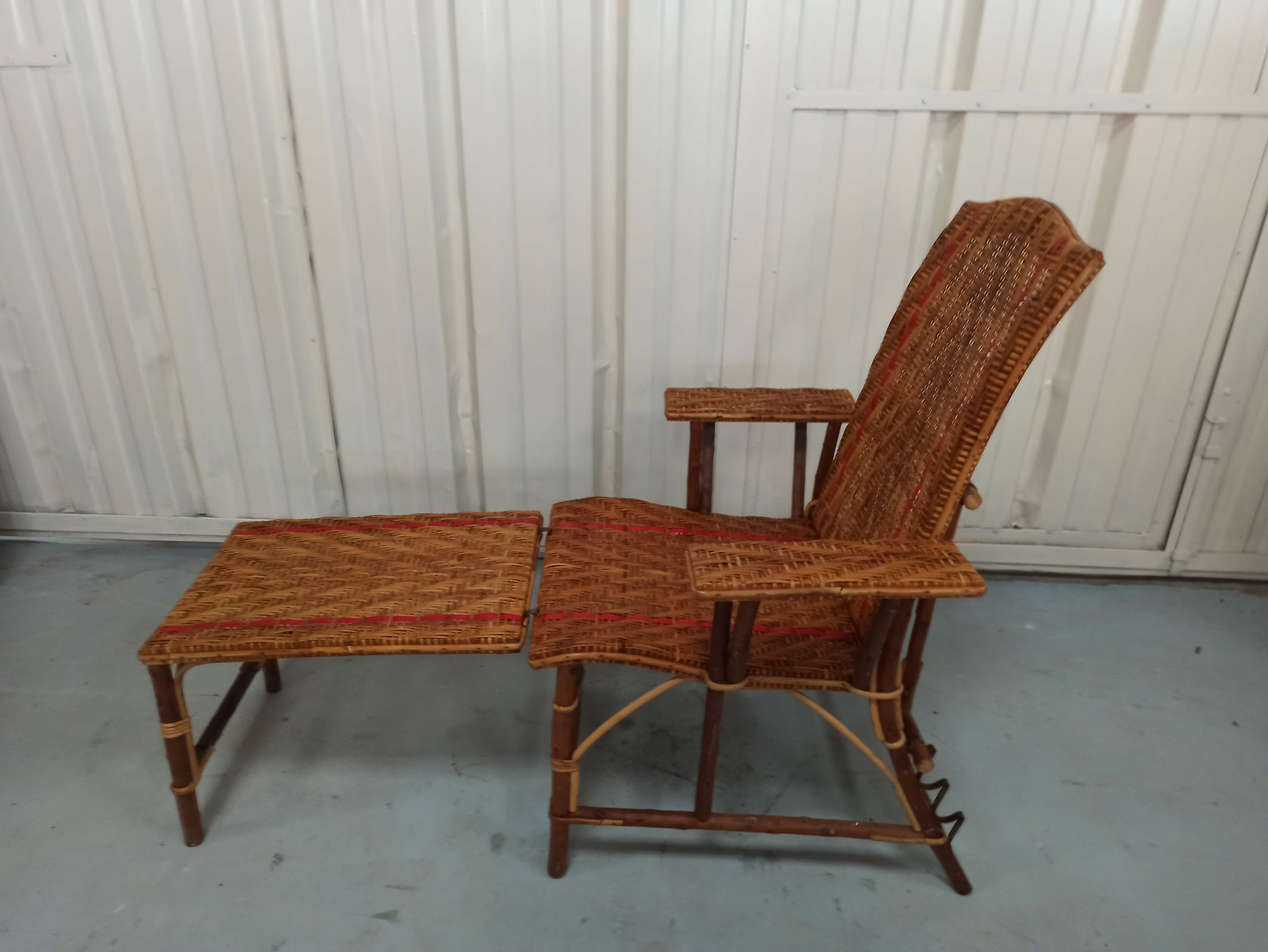 Sunbathing sunbathing in wicker rattan wood deckchair red lounger
