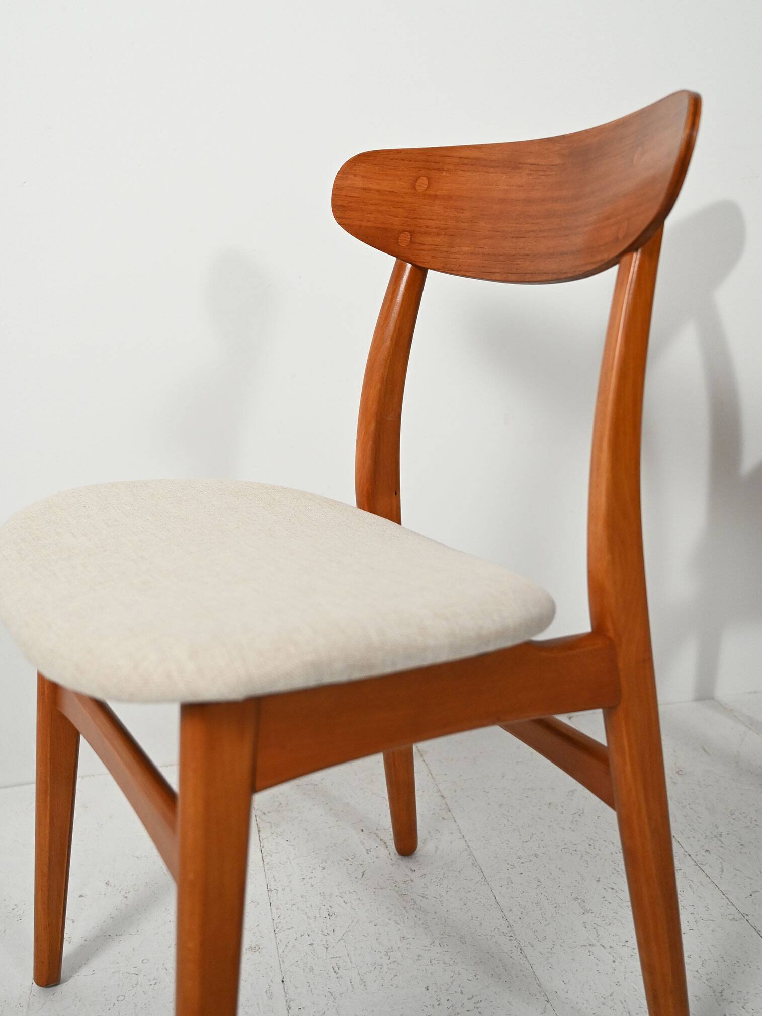 Pair of vintage teak chairs with a curved backrest