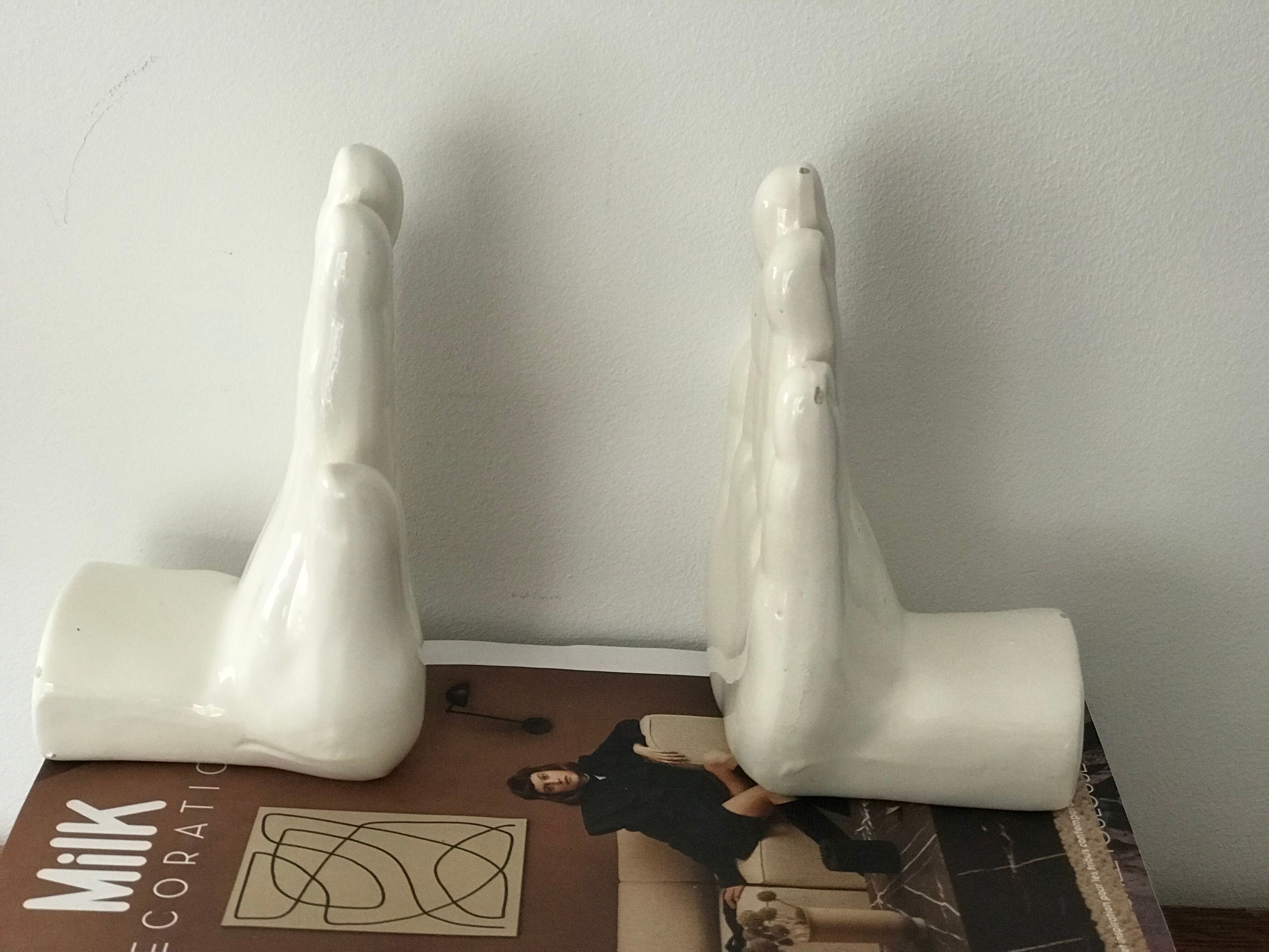 Hands tighten books in ceramics