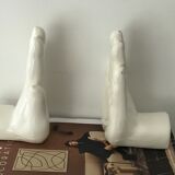 Hands tighten books in ceramics