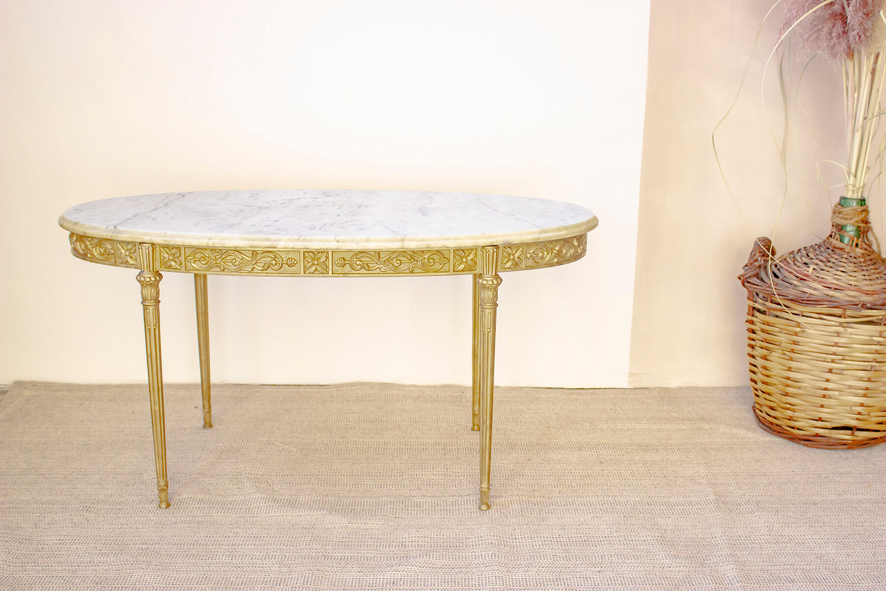 Oval coffee table in marble and brass