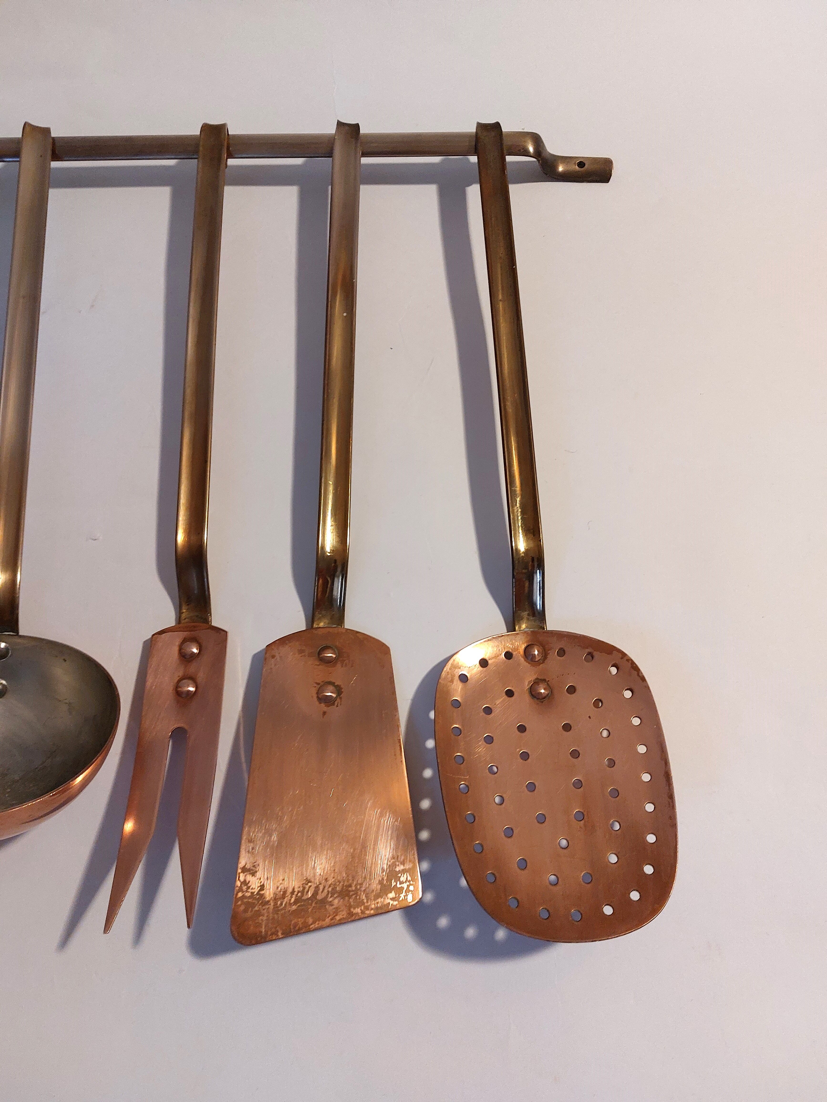 Vintage copper and brass kitchen utensils.