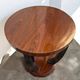 A round Art Deco coffee table made of beech wood and rosewood.