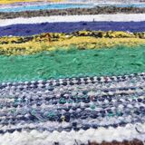 Vintage traditional nomadic kilim ethnic rug with multicoloured stripes.