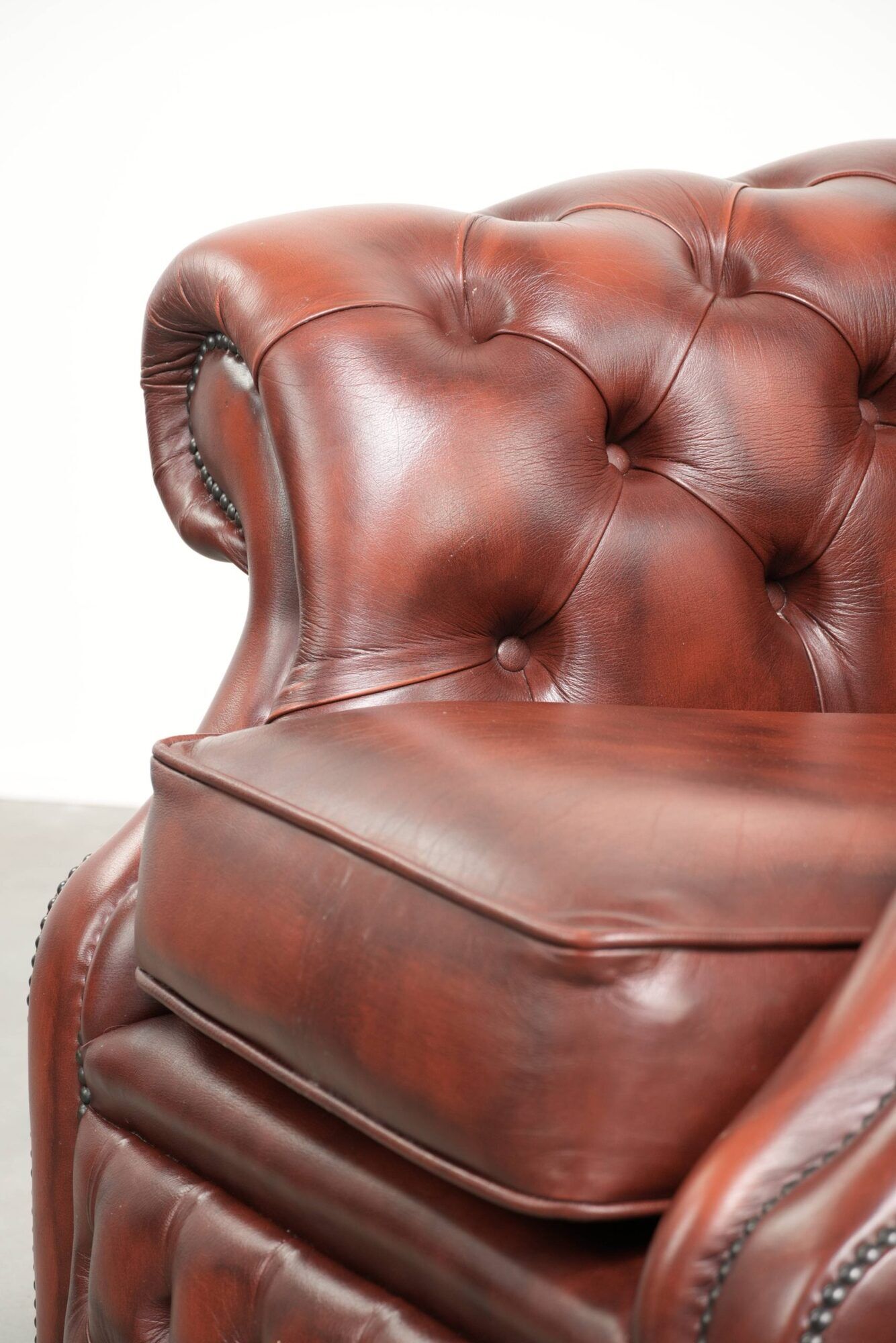 Cowhide chesterfield armchair in a warm brown colour with decorative nails