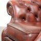 Cowhide chesterfield armchair in a warm brown colour with decorative nails