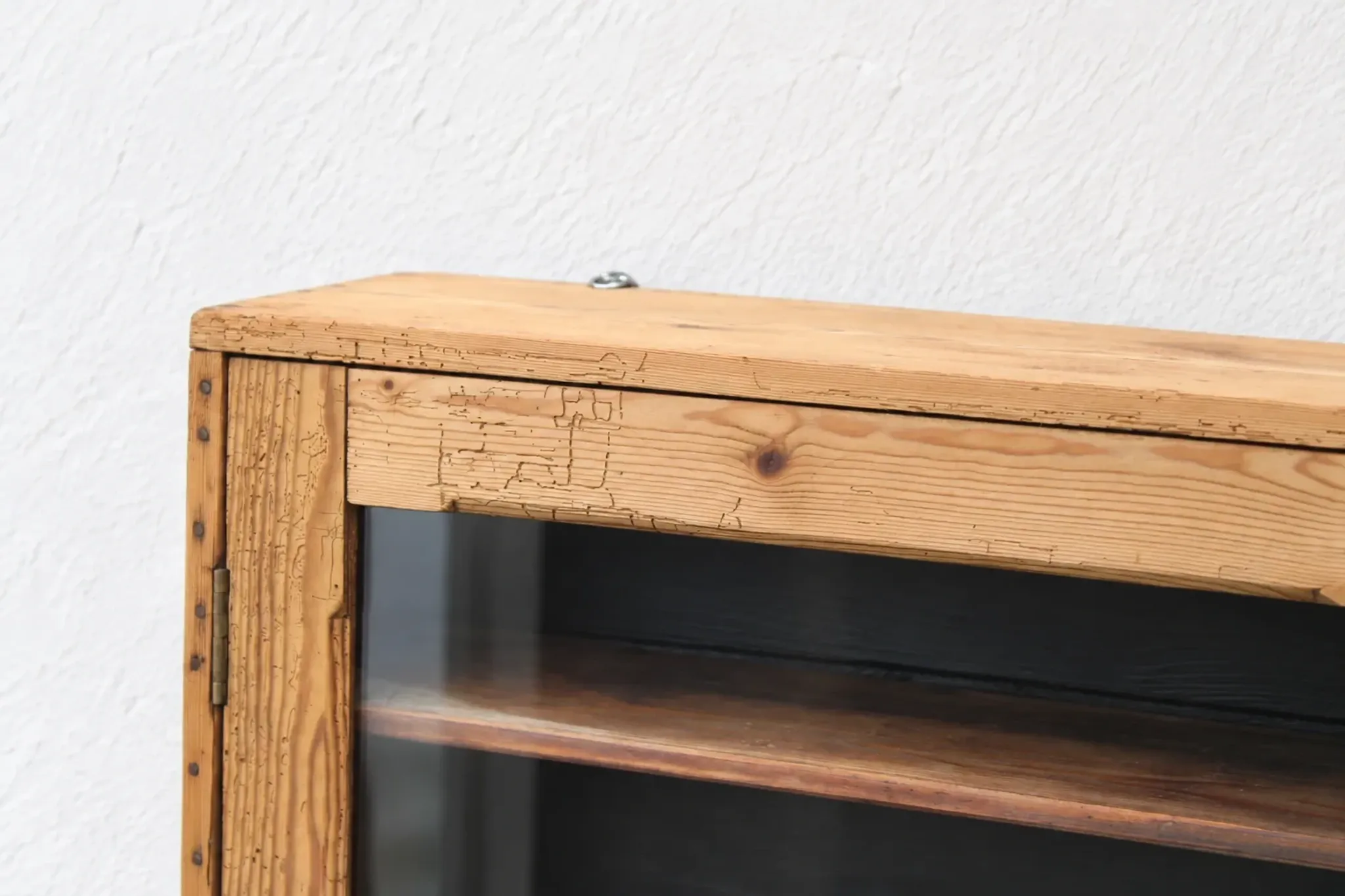 Antique wall display cabinet in natural wood and black – small glass-fronted collector's piece.