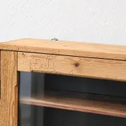 Antique wall display cabinet in natural wood and black – small glass-fronted collector's piece.